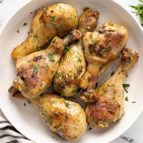 Close up overhead view of ranch chicken drumsticks in a bowl.