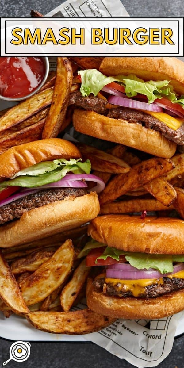 Overhead shot of three Smash Burgers tucked into a tray with fries nestled around them.