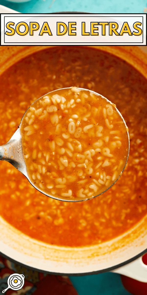 Overhead shot of Sopa De Letras in a pot with a ladle holding up a portion.