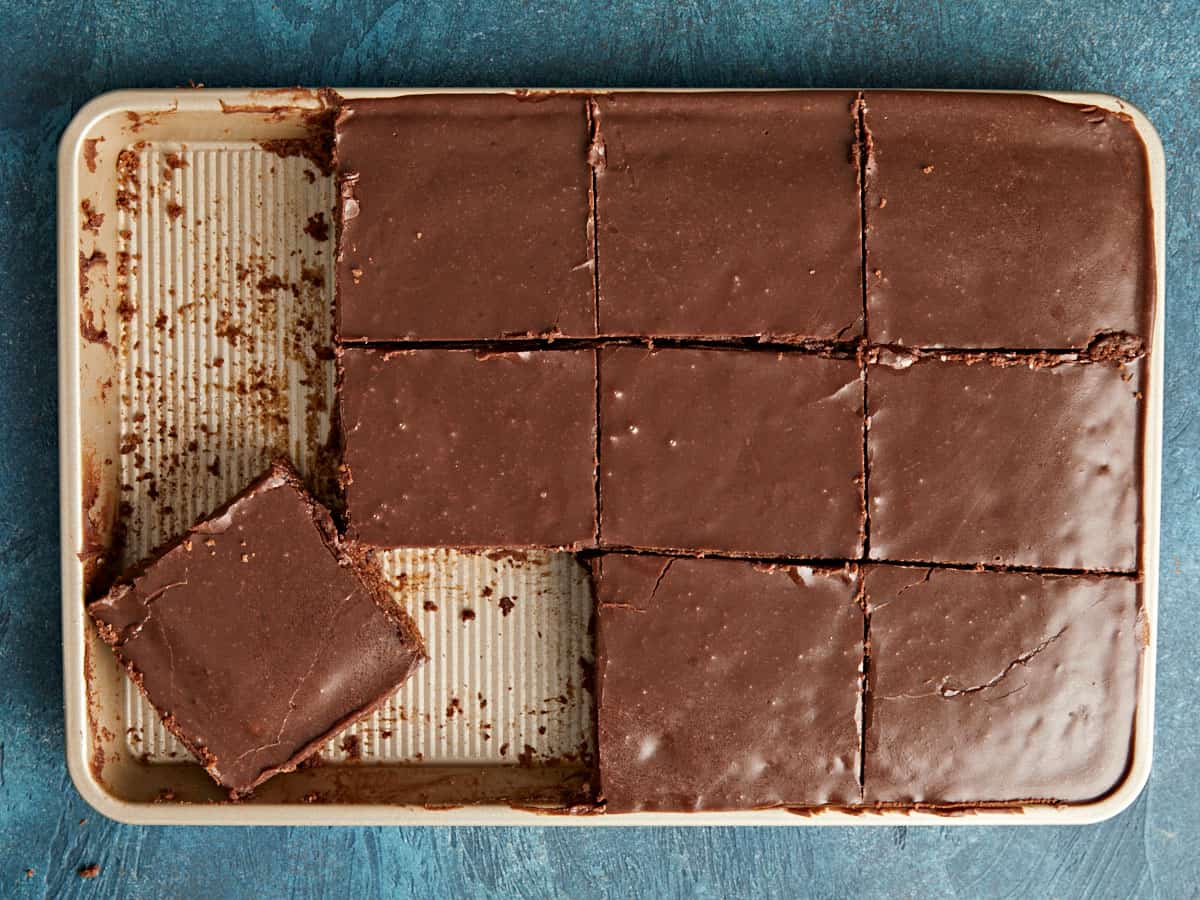 Sliced Texas sheet cake with one slice half removed. 