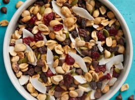 Overhead close up view of a bowl full of trail mix.