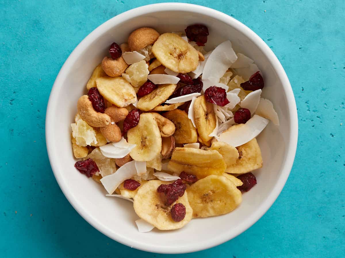 Overhead view of a bowl full of tropical trail mix.
