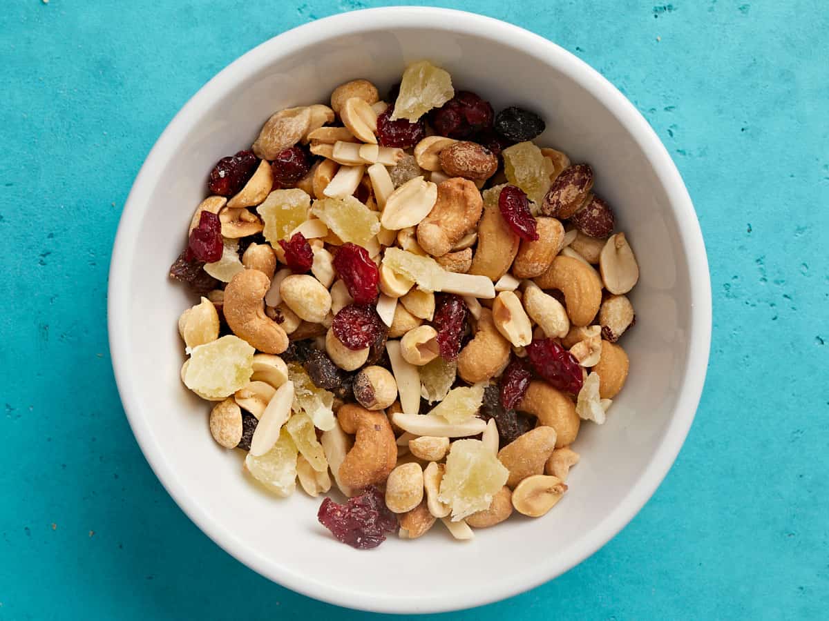 Overhead view of a bowl of fruit and nut trail mix.