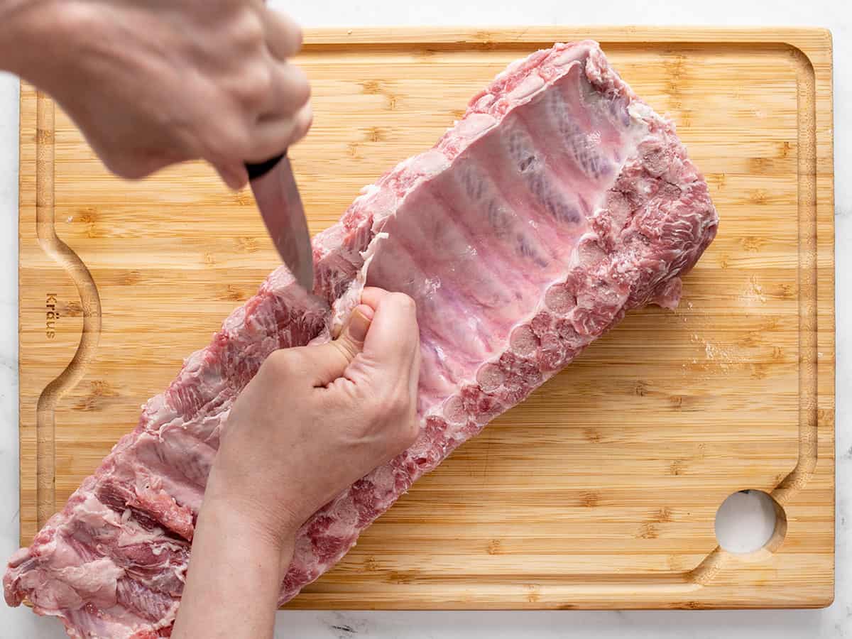 Trimming silver skin off the back of a rib rack.