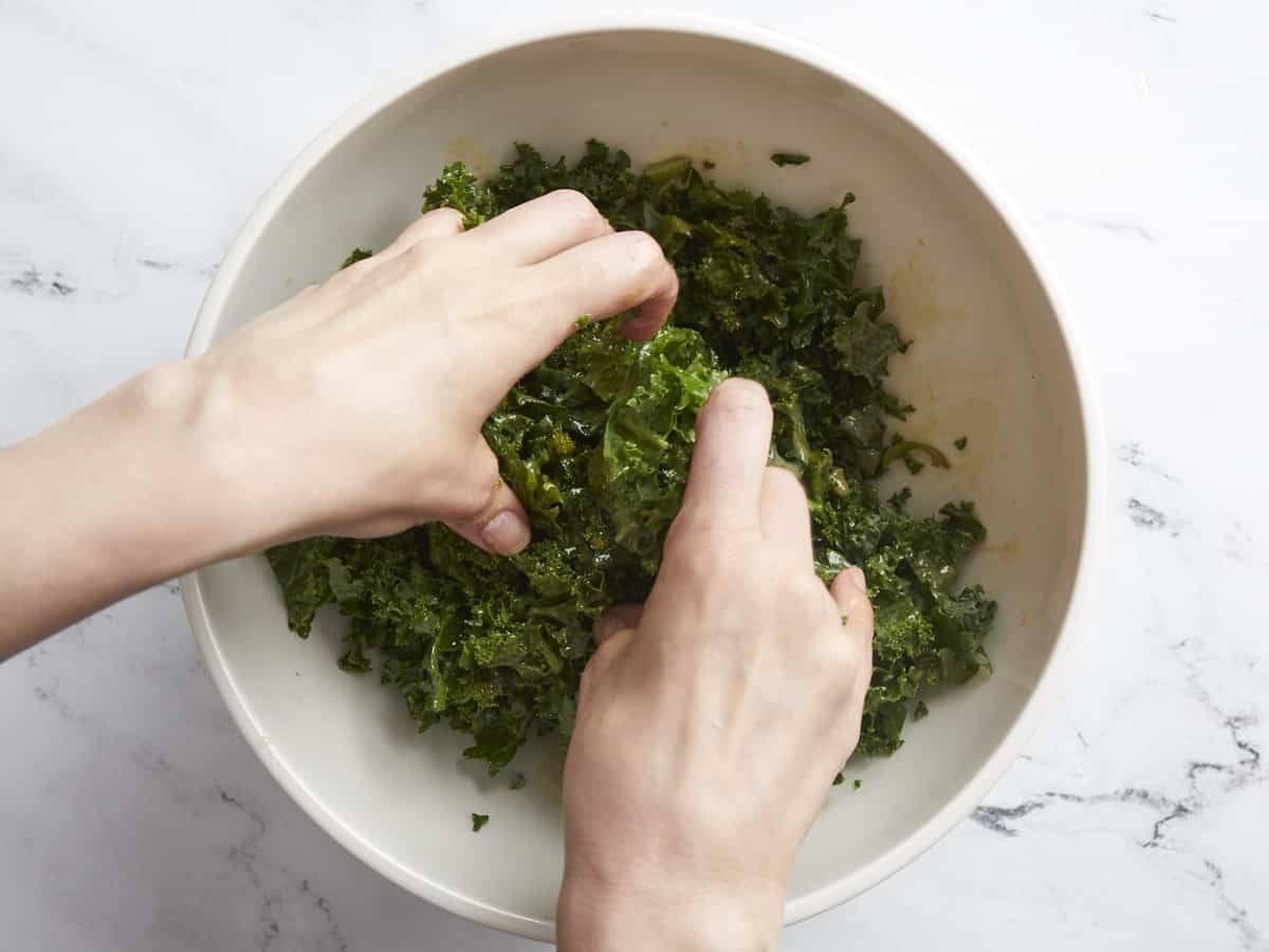 Overhead shot of kale being massaged.