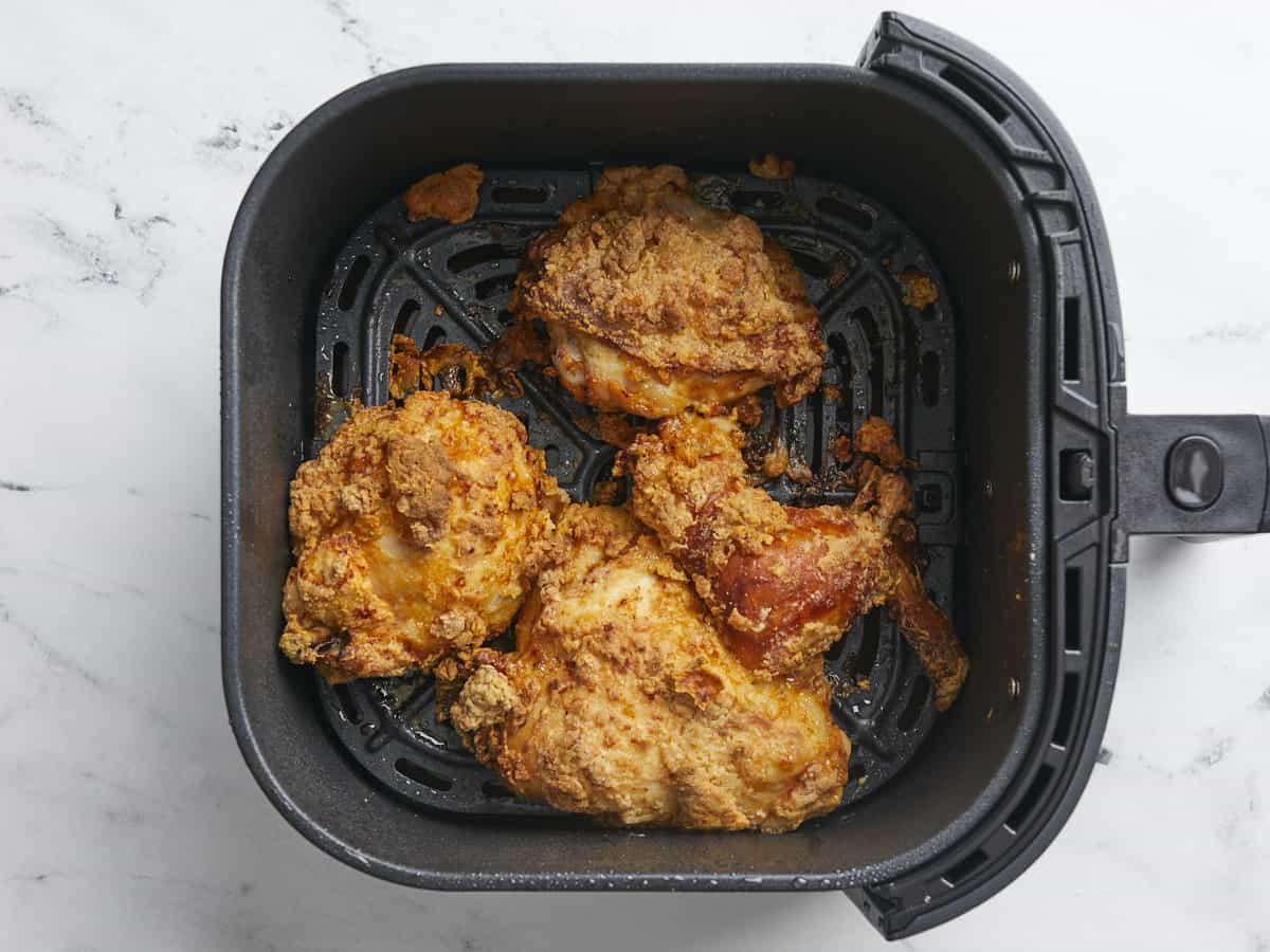 Overhead shot of finished air fryer fried chicken in an air fryer basket.
