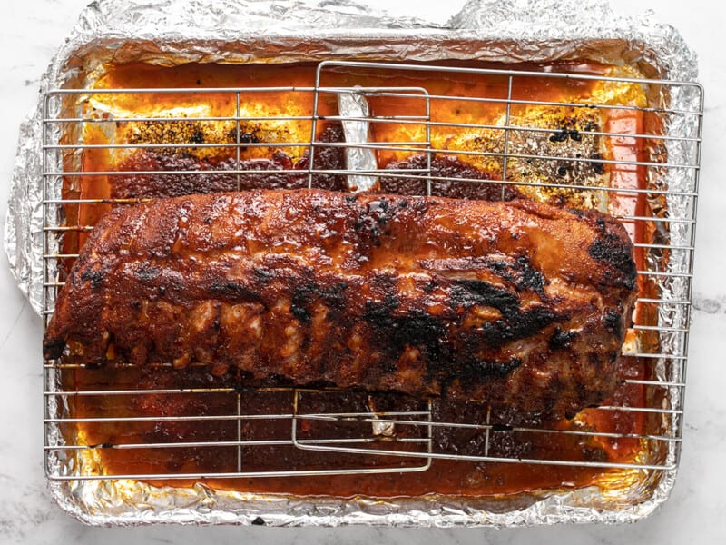 Finished baked ribs on a rack.