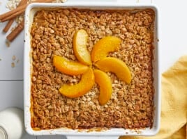 Overhead shot of Peach Baked Oatmeal in a white baking dish.