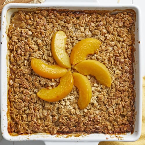 Overhead shot of Peach Baked Oatmeal in a white baking dish.