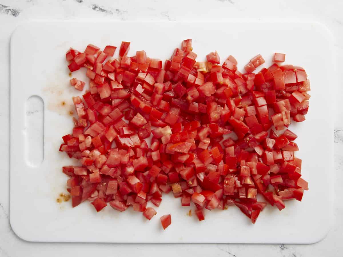 Diced tomatoes on a cutting board.