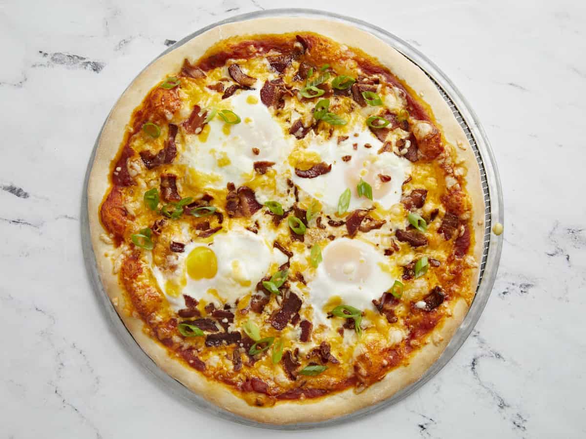 Breakfast pizza topped with green onions.