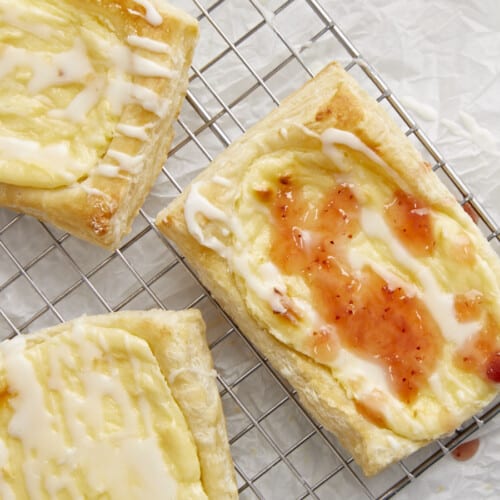 Overhead shot of three cheese danish on a cooling rack.