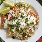Overhead shot of chilaquiles served on a white plate.