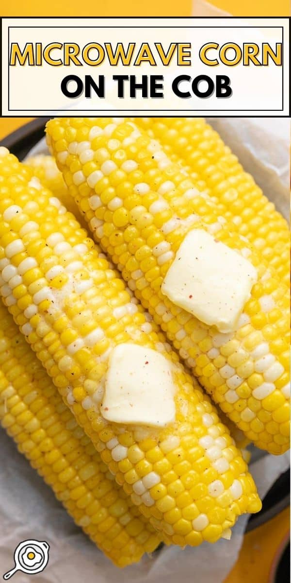 Overhead shot of cobs of Microwave Corn On The Cob on a black plate with two pats of butter melting on top.