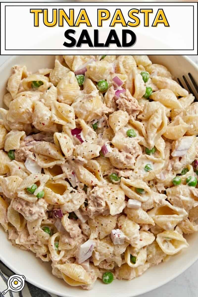 Close up overhead view of a bowl full of tuna pasta salad with title text at the top.
