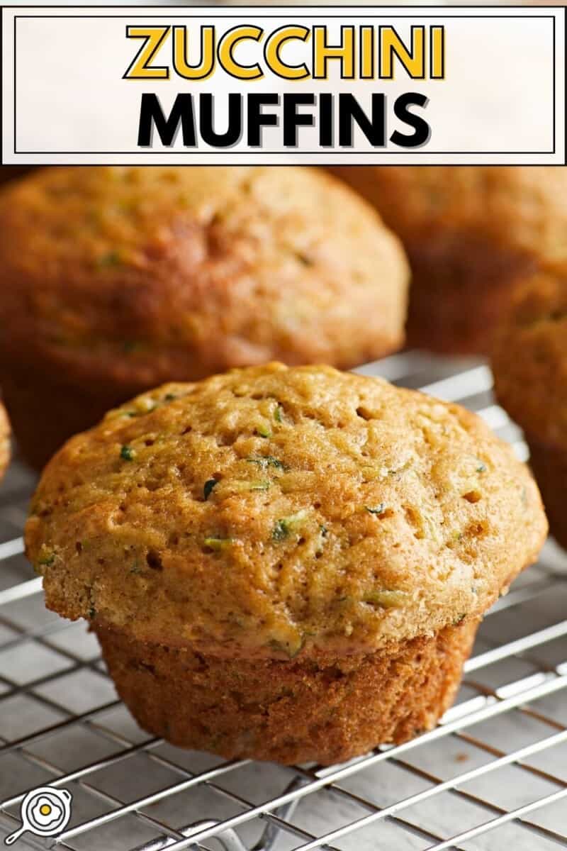 Close up view of zucchini muffins on a wire rack.
