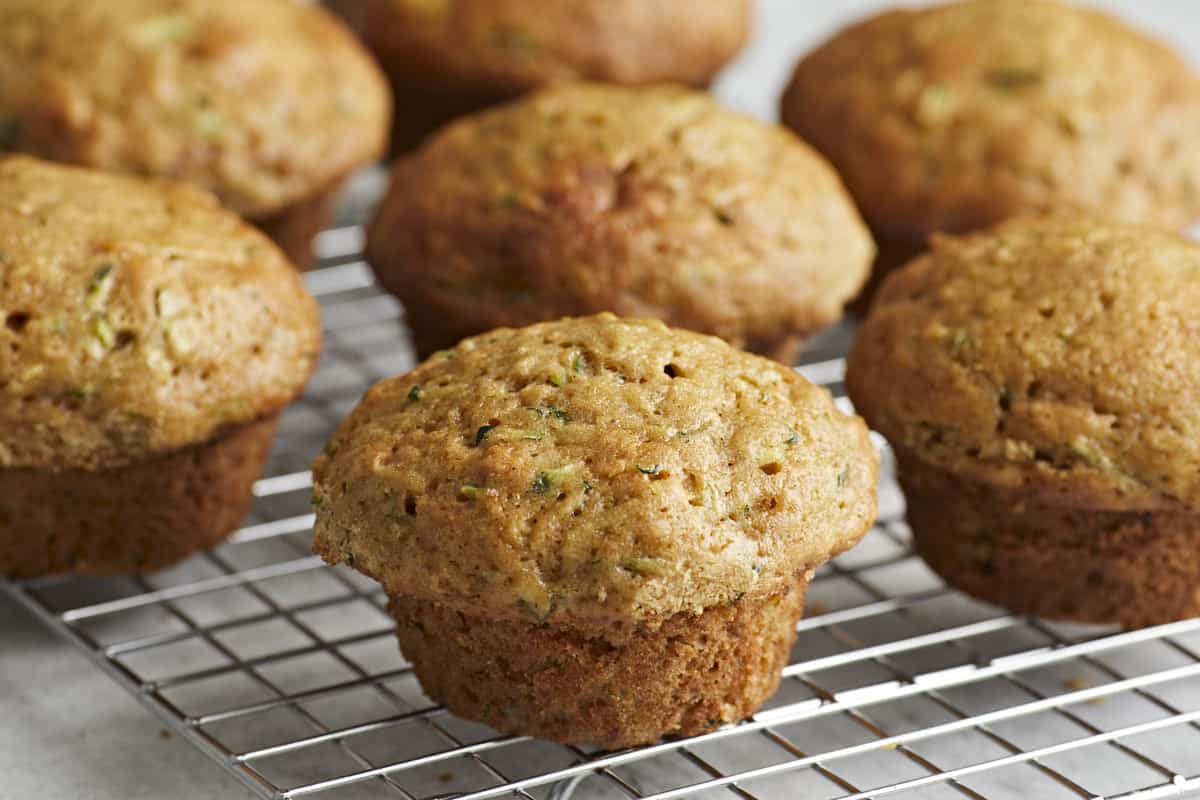 Side view of Zucchini muffins on a wire rack.