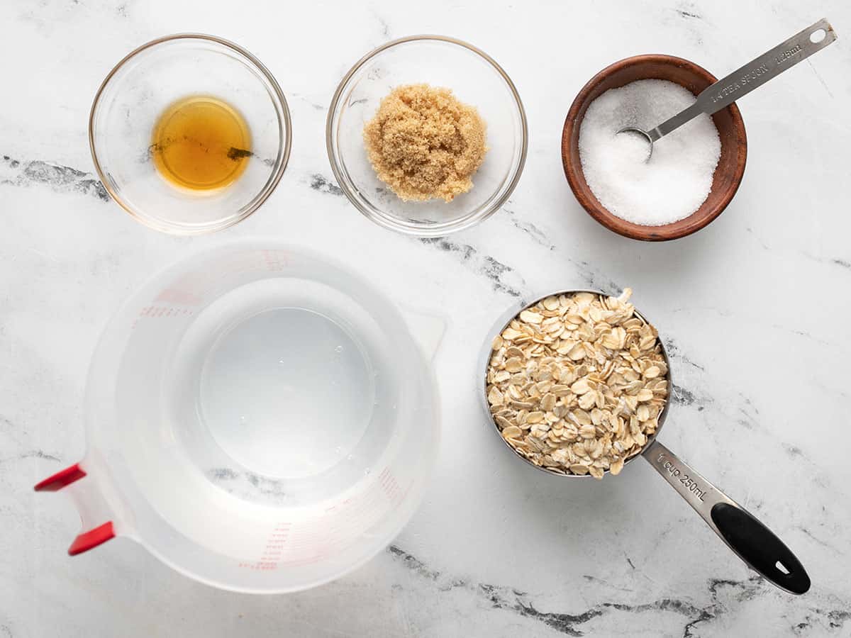 Oat milk ingredients laid out on a surface.