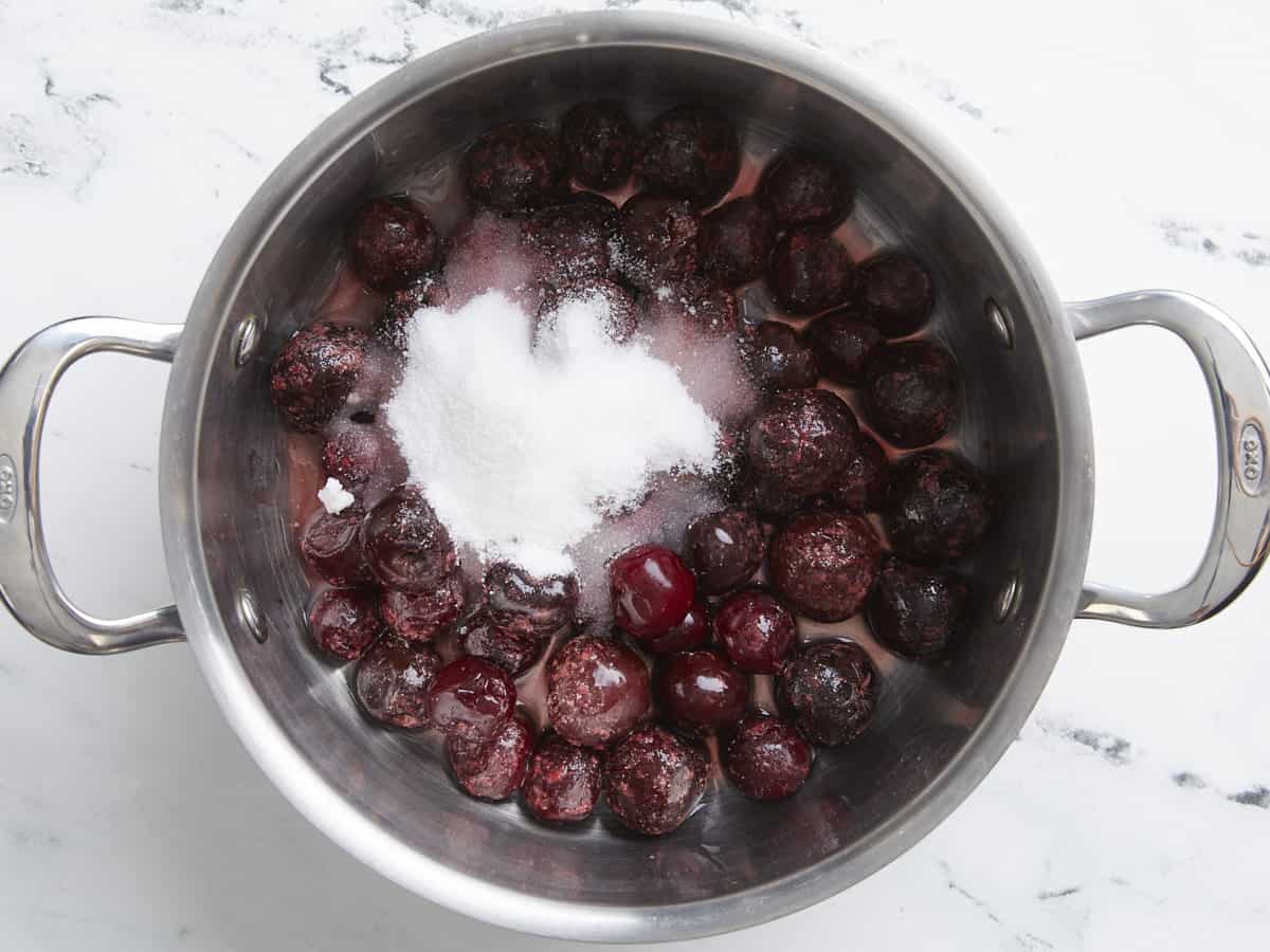 Cherries, sugar, and water in a sauce pot.