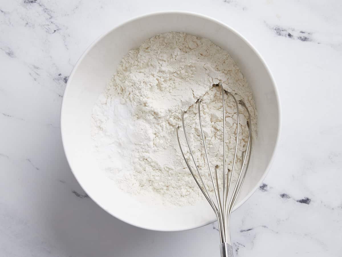 Dry ingredients for lemon pound cake being whisked together in a bowl.