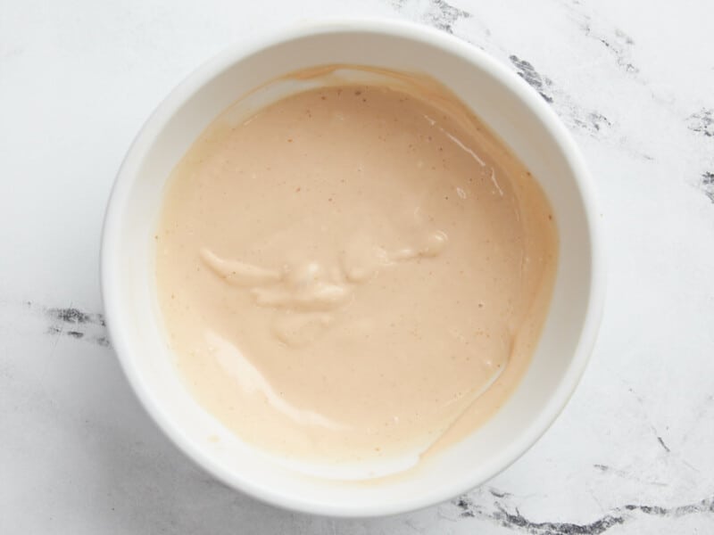 Overhead shot of sauce in a small white bowl.