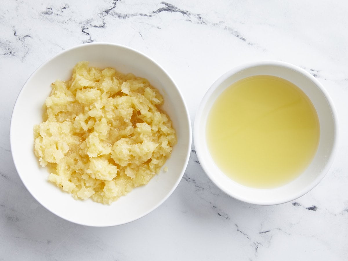 Crushed pineapples with the juice drained into a separate bowl.