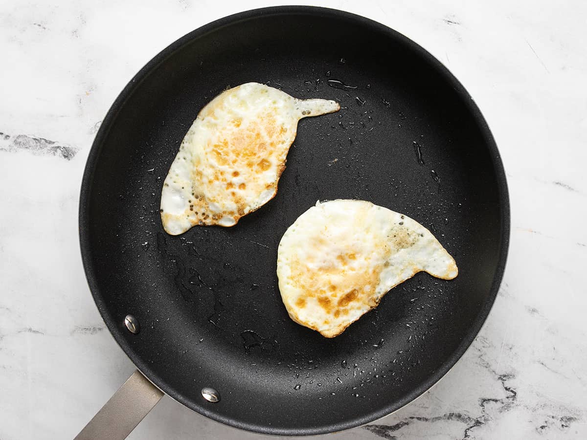 Two fried eggs in a skillet.
