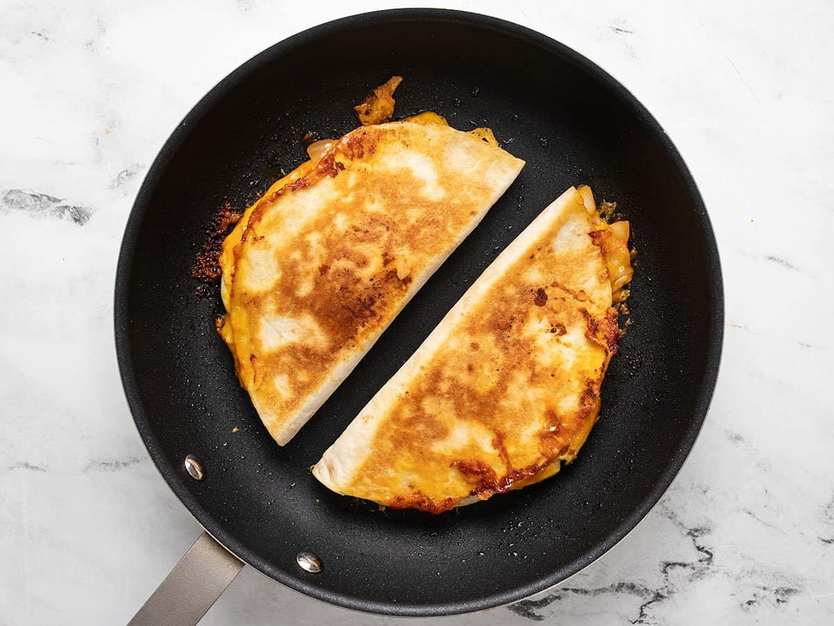 Toasted quesadillas in the skillet.