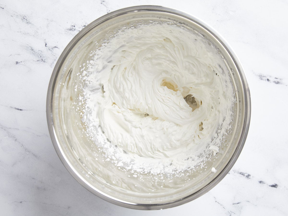 Whipped cream in a mixing bowl.