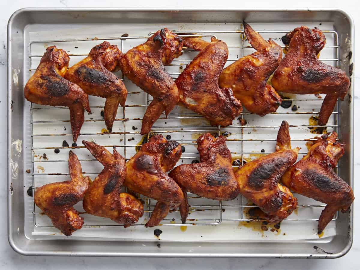 Overhead shot of finished BBQ Wings on a rack set over a sheet pan.