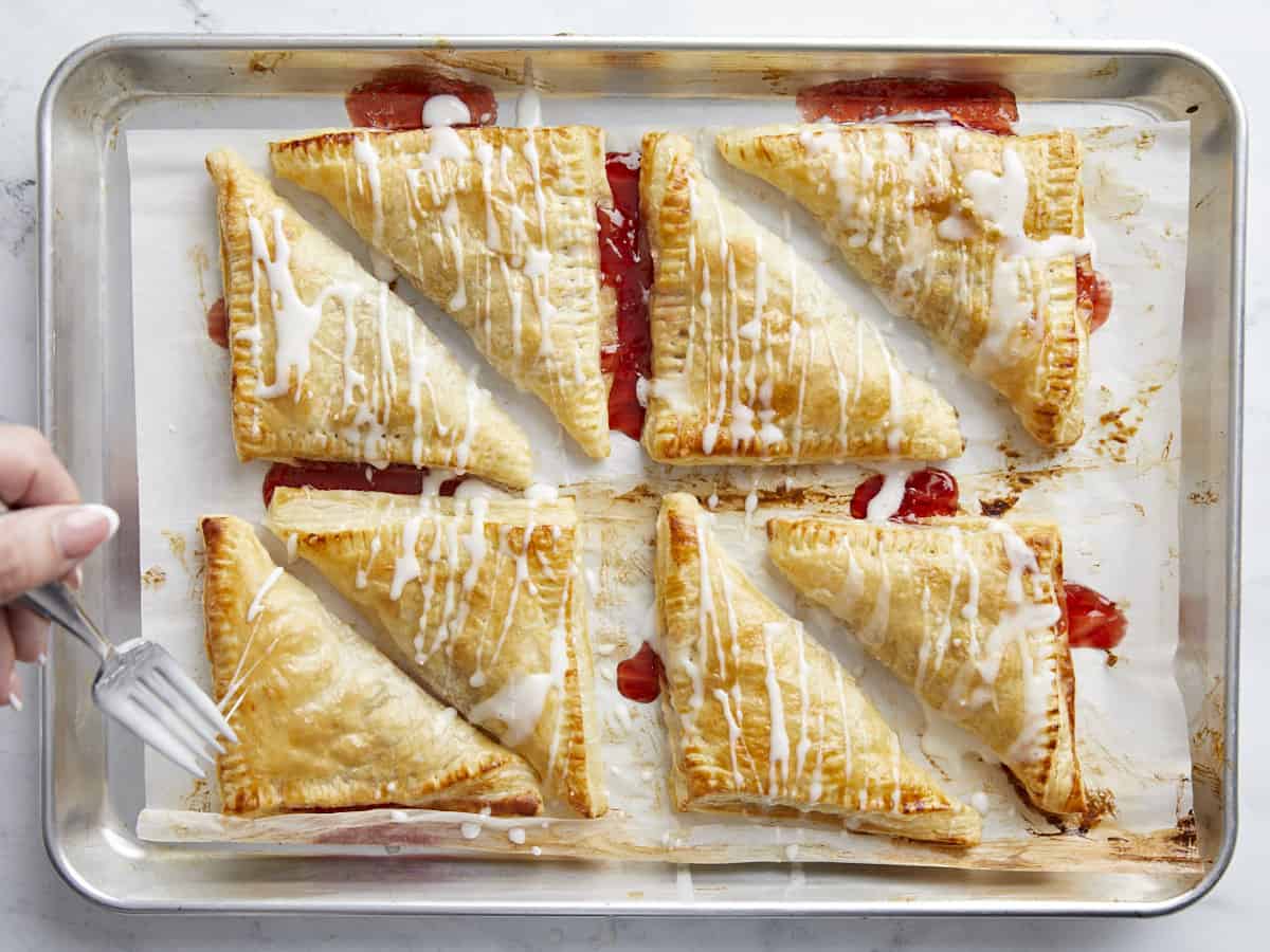 Puff pastries being glazed.