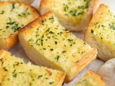 Close up side view of slices of garlic bread.