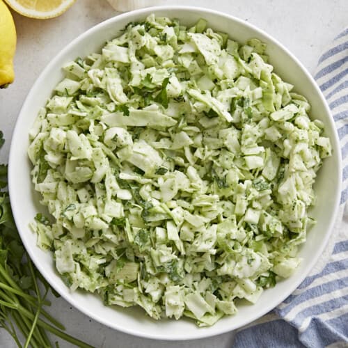 Overhead shot of Green Goddess Salad in a white bowl.