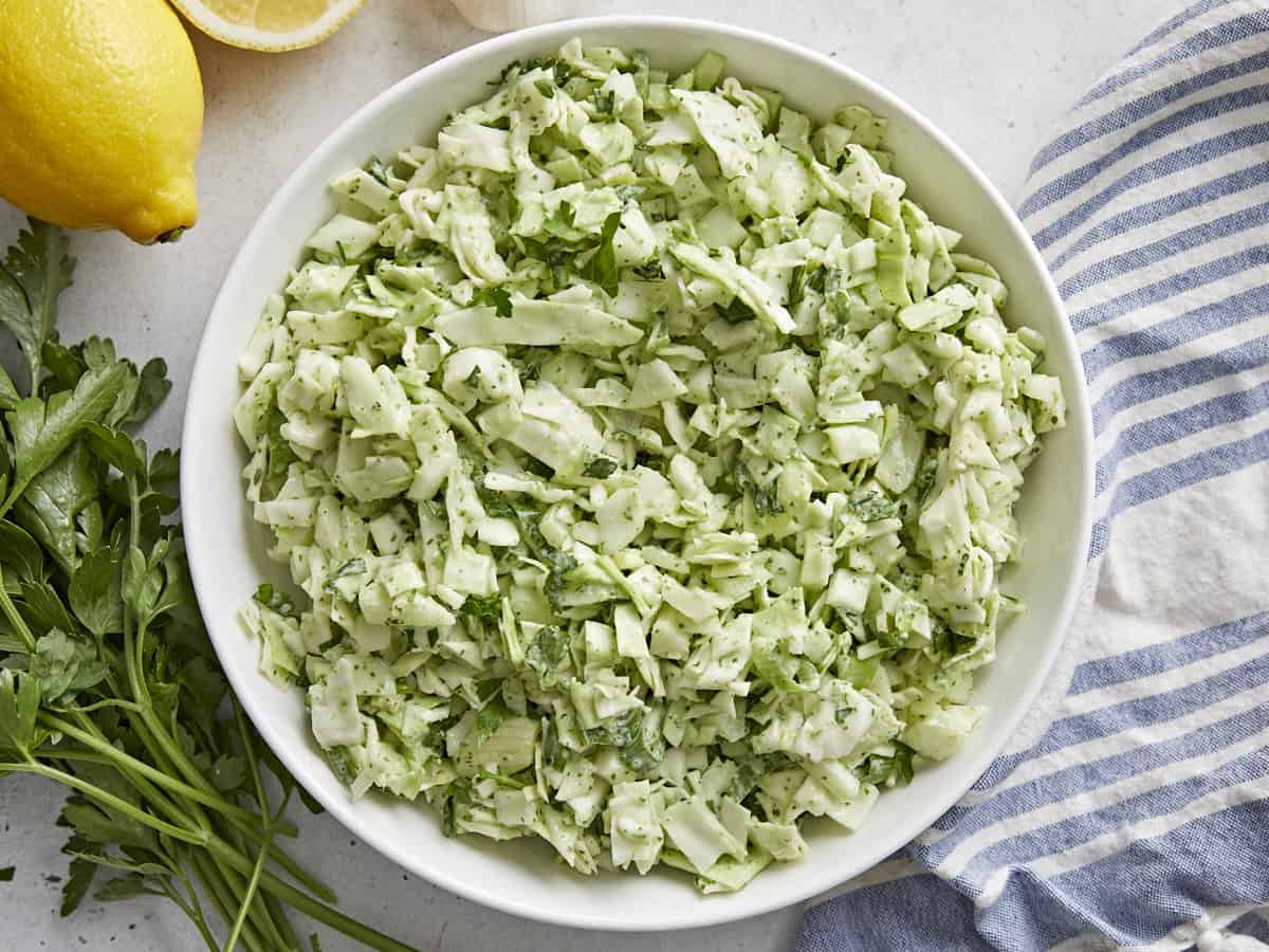 Overhead shot of Green Goddess Salad in a white bowl.