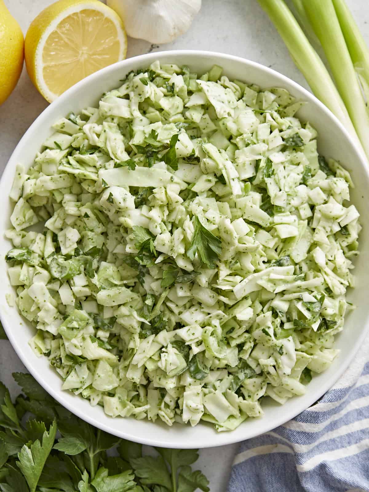 Overhead shot of Green Goddess Salad in a white bowl.