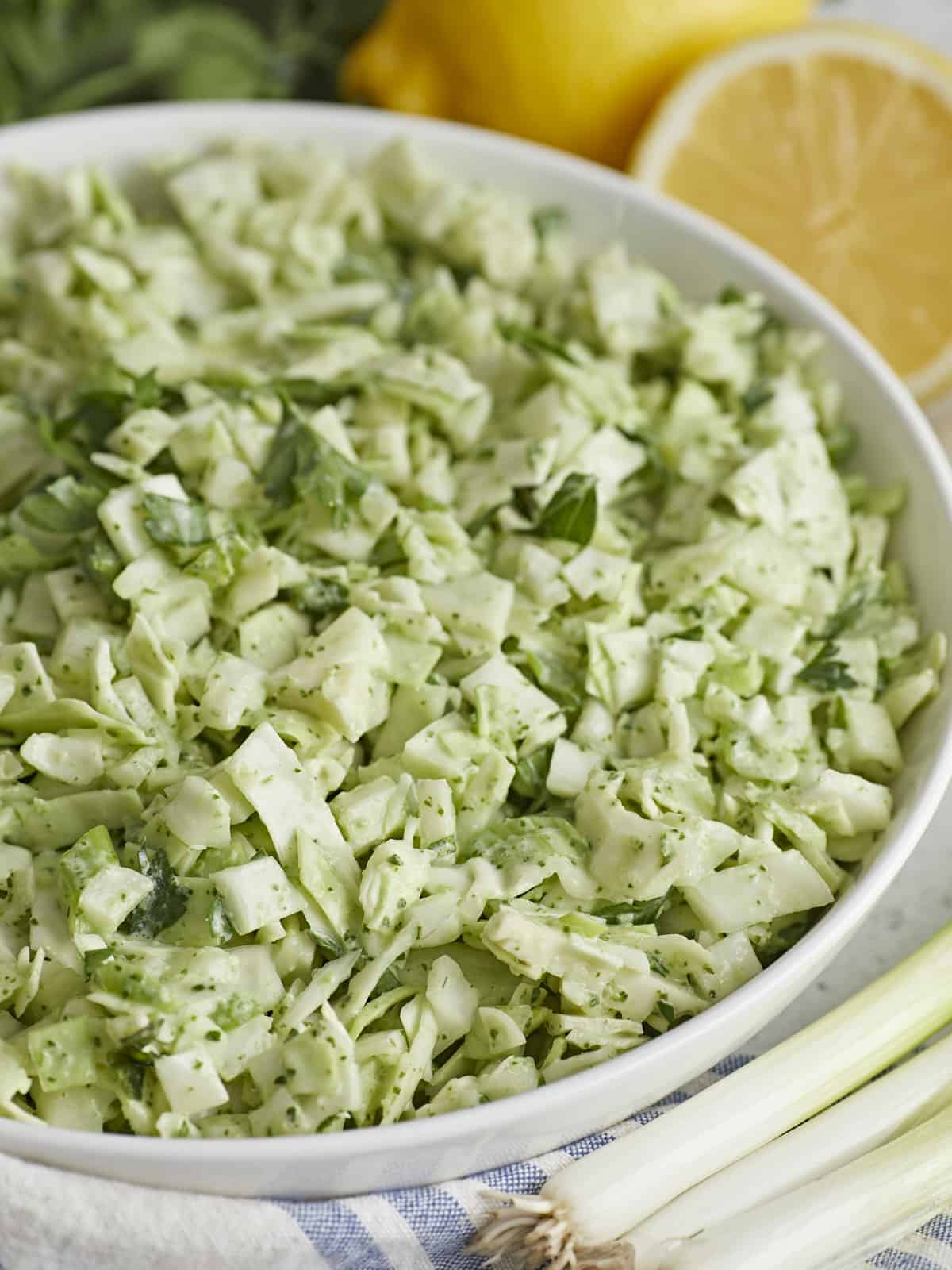 Side shot of Green Goddess Salad in a white bowl.