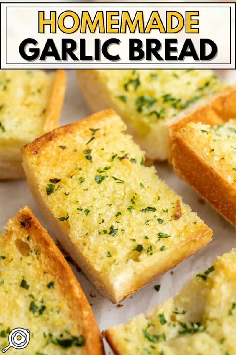 Slices of homemade garlic bread scattered on a surface.