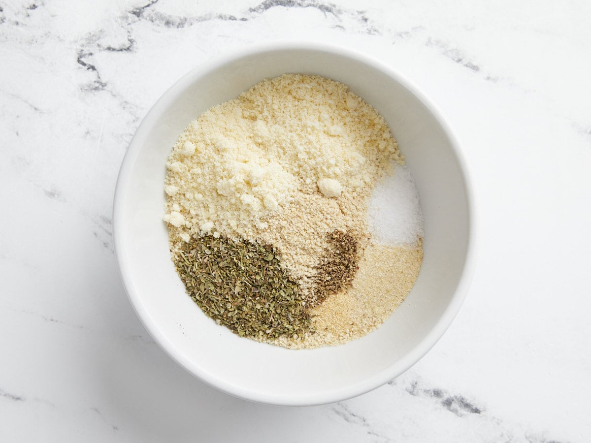 Dry ingredients for turkey meatballs in a bowl, unmixed.