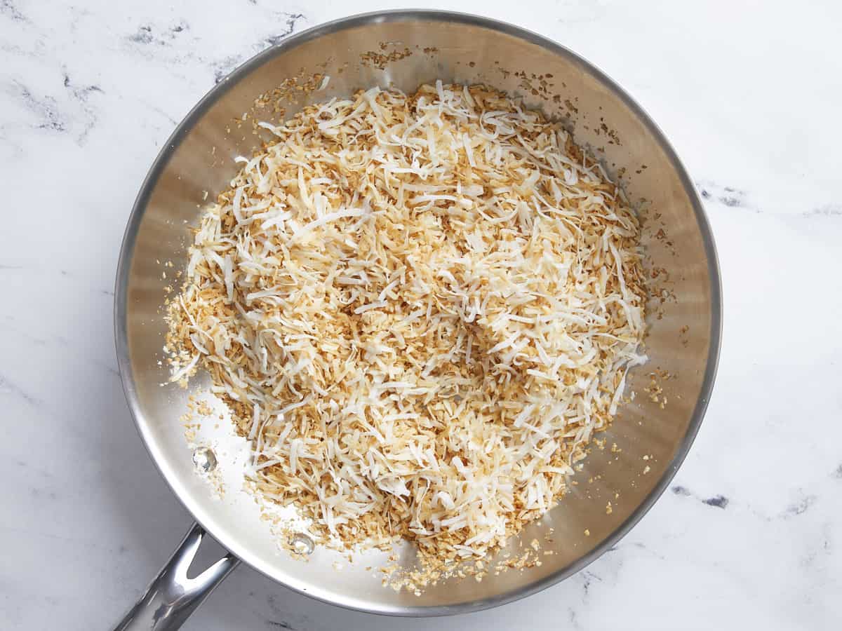 Toasted coconut in a skillet.