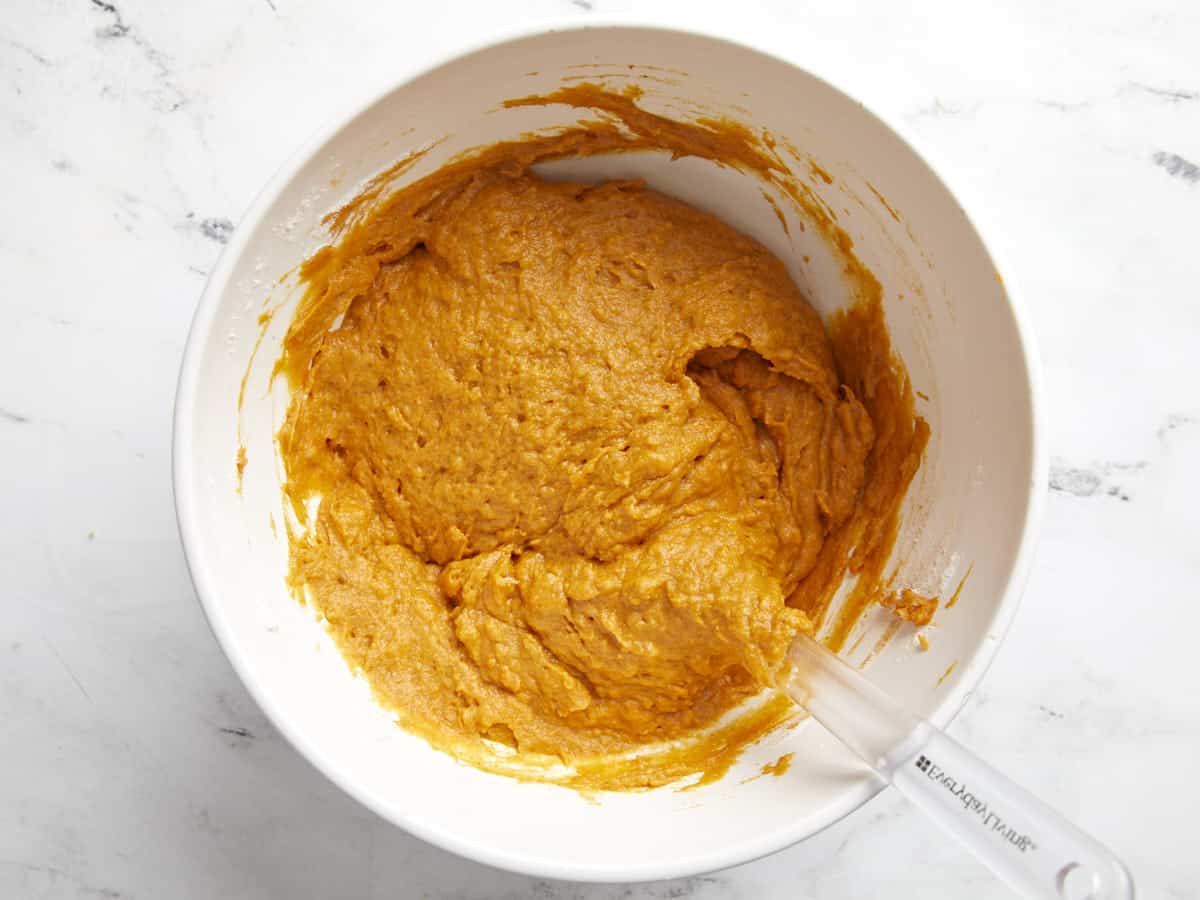 Pumpkin muffin batter mixed together in the bowl.