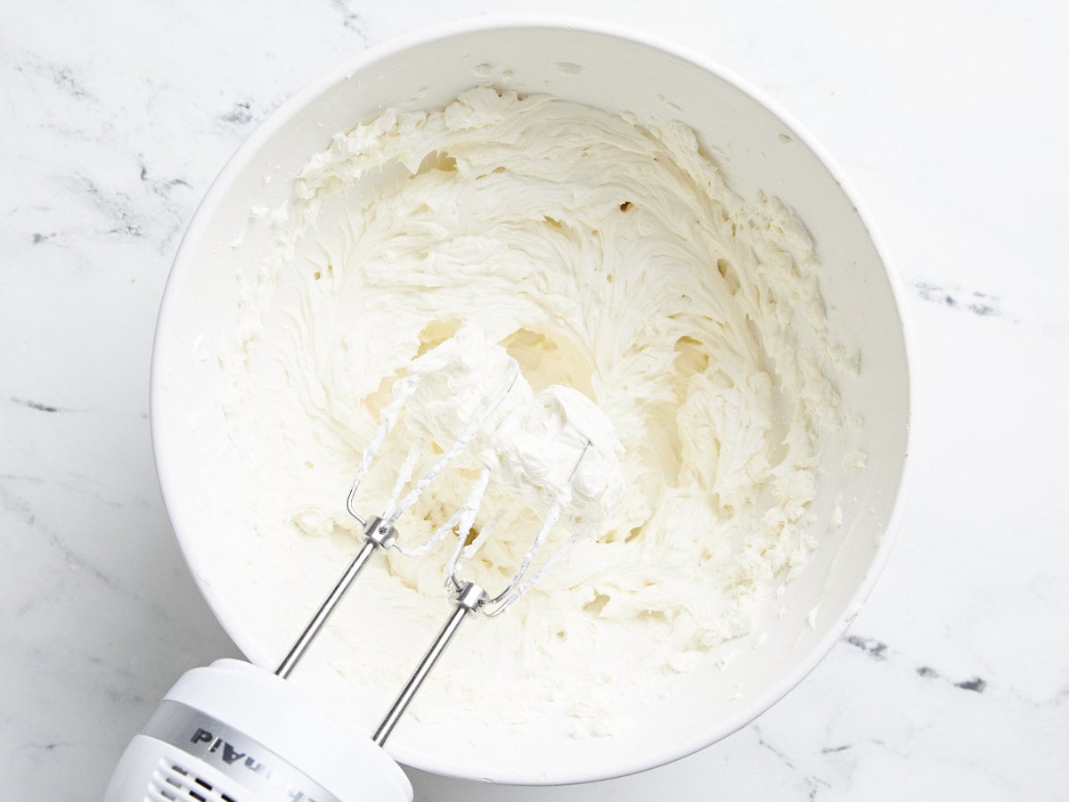 Cream cheese, yogurt, and vanilla whipped in a bowl with a hand blender.