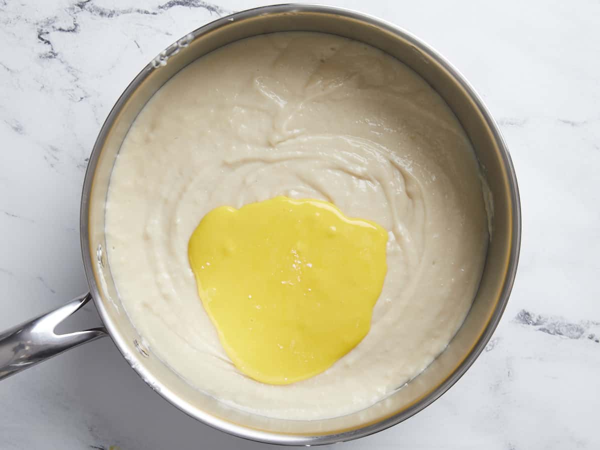 Add egg yolk slurry to custard. 