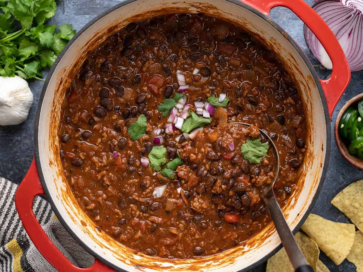 Overhead view of a pot full of black bean chili.