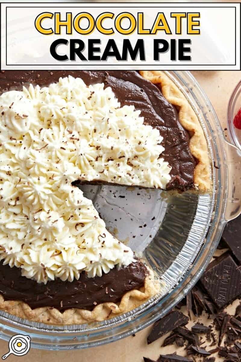 Overhead view of a chocolate cream pie with a slice taken out.