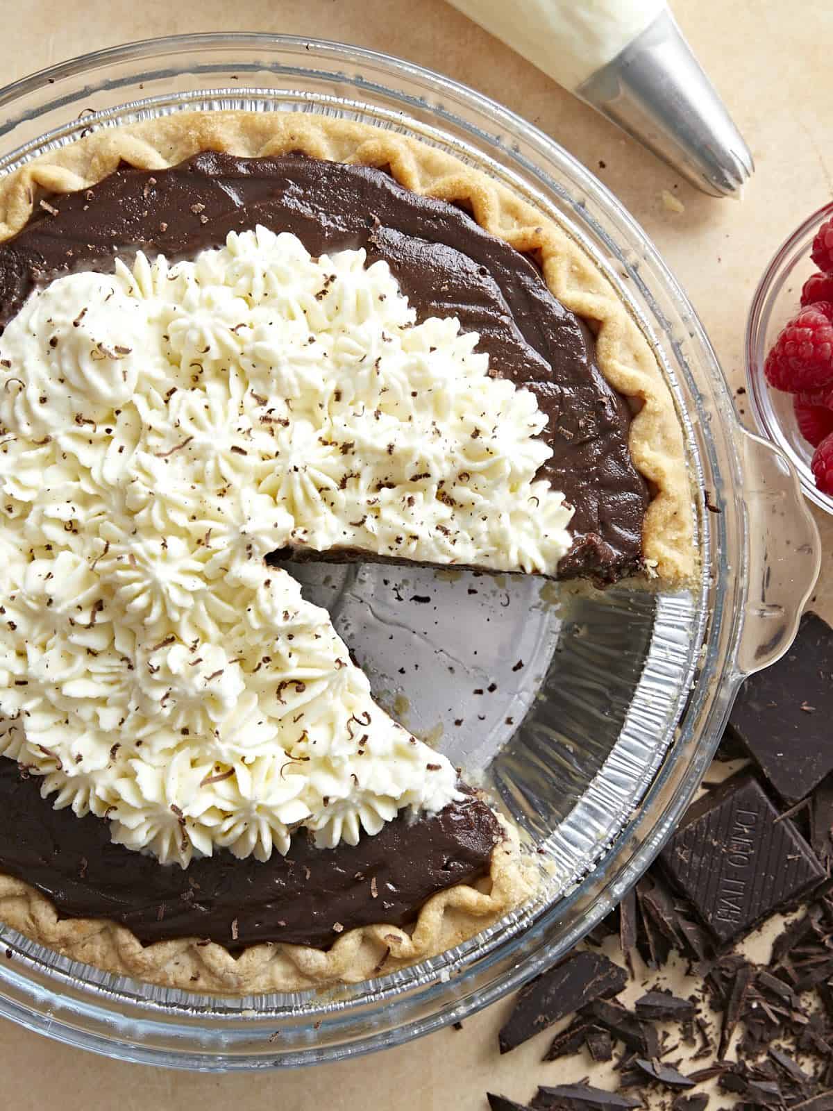 Close up overhead view of a chocolate cream pie topped with whipped cream.