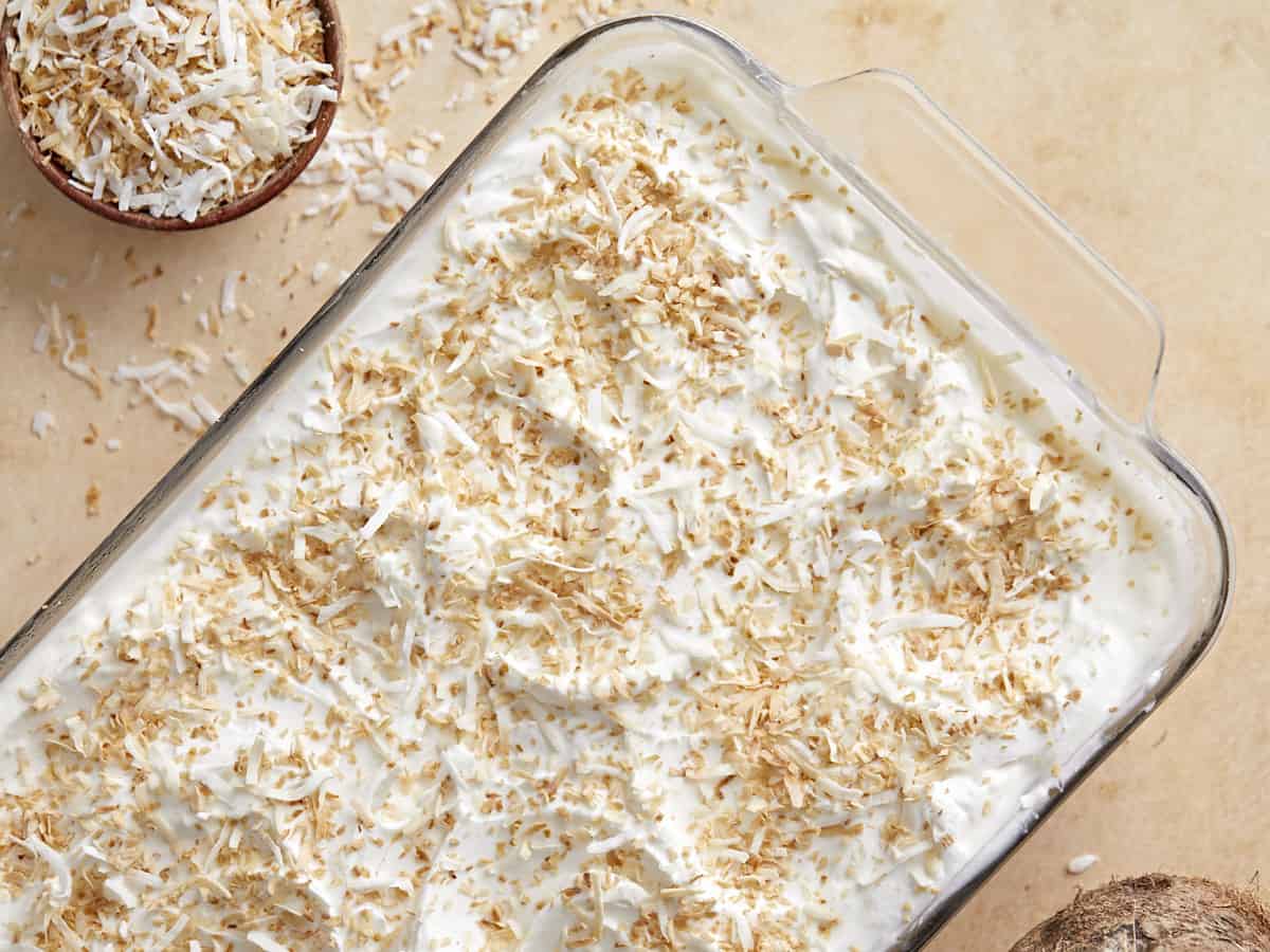 Overhead view of coconut cream pie bars in the casserole dish. 