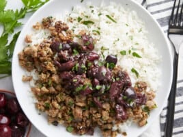 Close up overhead view of a pork and cherry rice bowl.