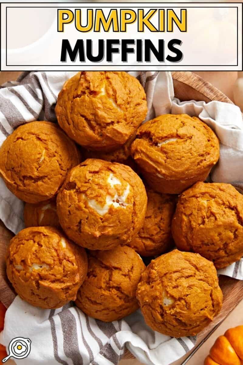 Overhead view of pumpkin muffins in a basket with a towel.