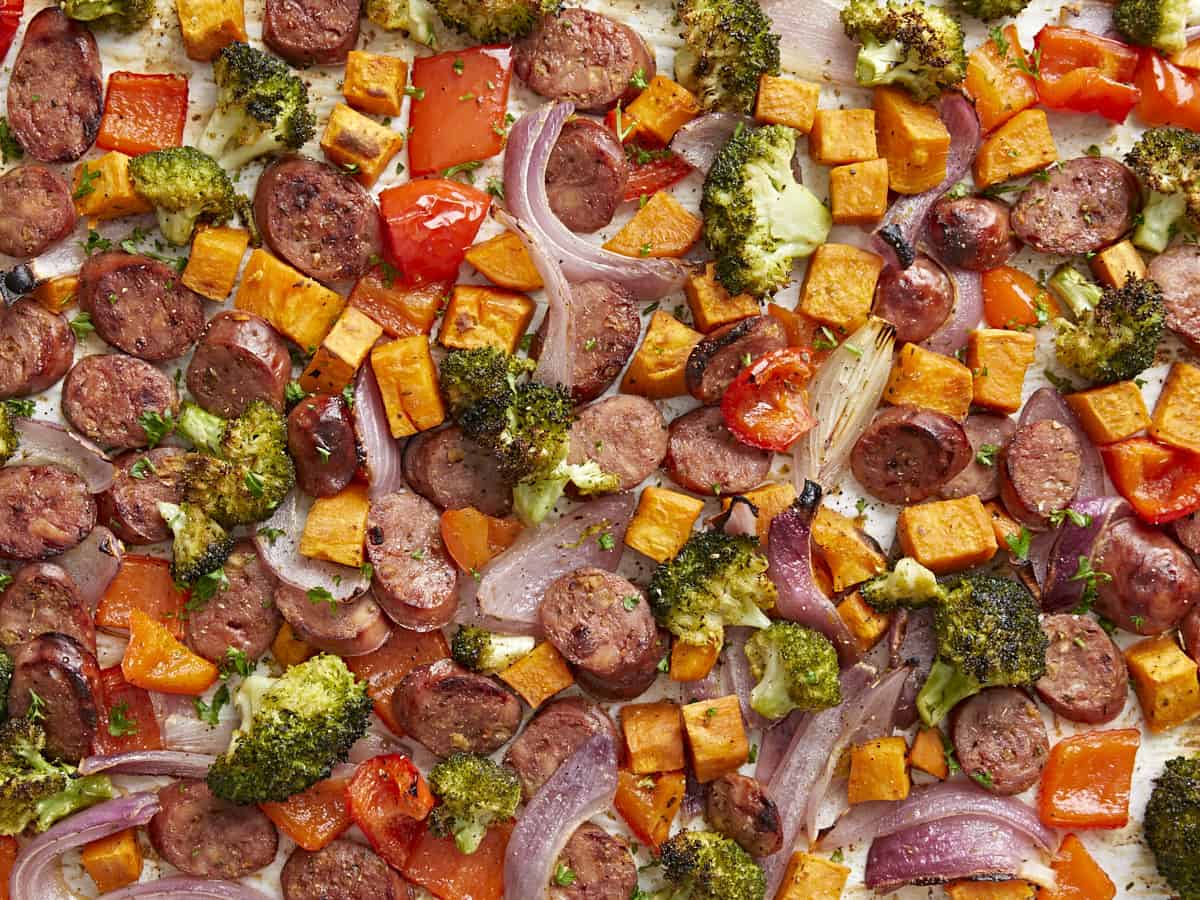 Close up overhead photo of sheet pan chicken sausage and vegetables dinner.