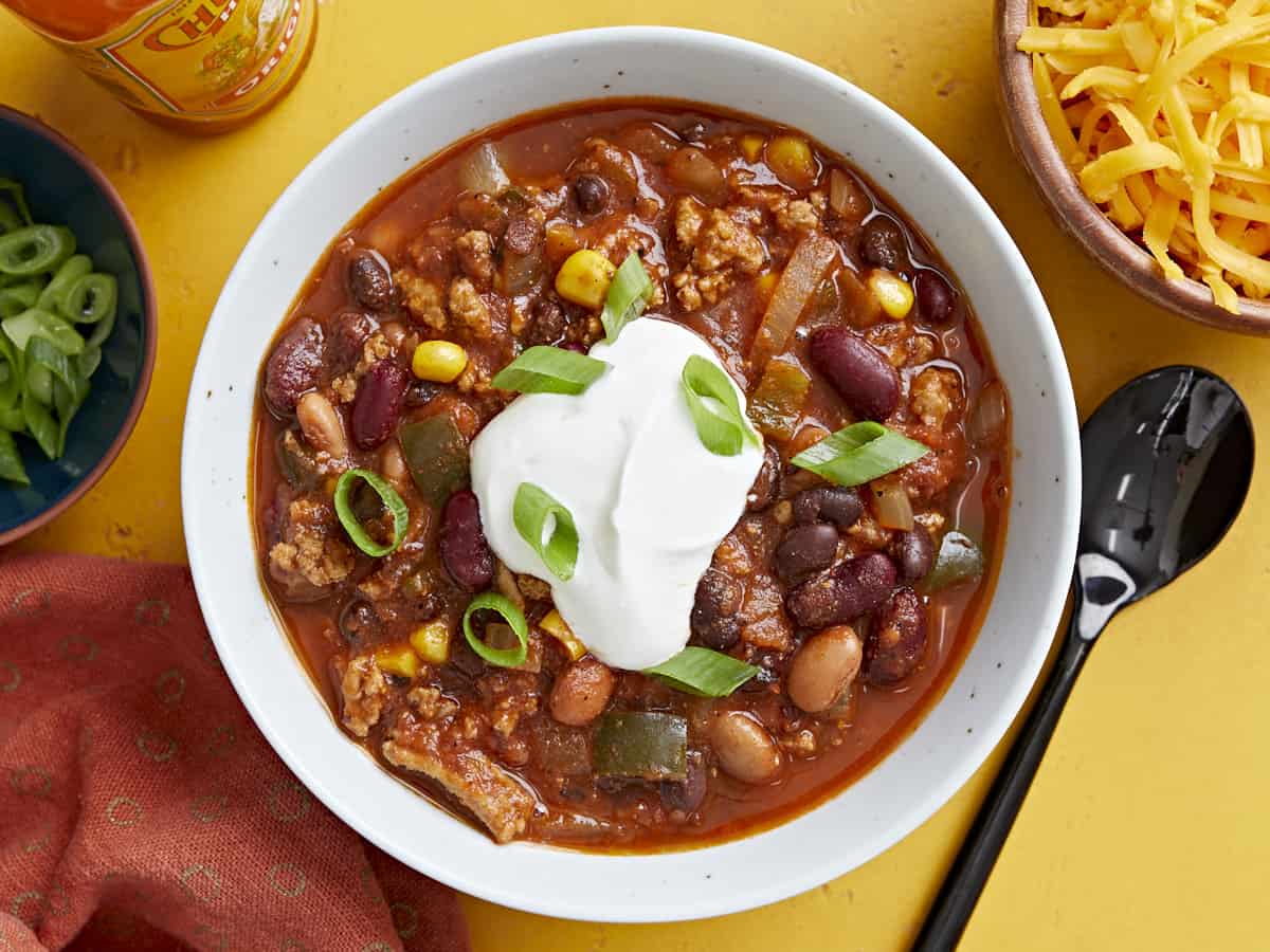 Overhead view of a bowl full of chili with toppings.